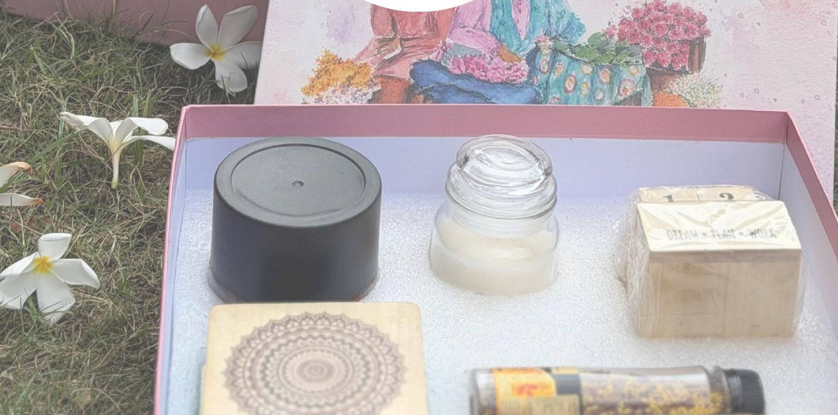 Curated corporate gift box opened, showing the painted lid and contents